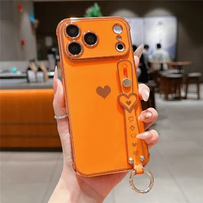 For iPhone 18 Pro Max / 17 Pro Max Case Wristband Kickstand Electroplated Love Heart TPU Phone Cover Finger Holder - Orange